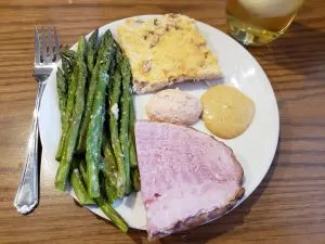 Keto Spicy Sweet Mustard on a dinner plate with ham, asparagus and twice baked cauliflower