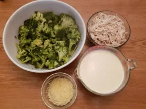 bowls of broccoli, chicken, alfredo sauce and cheese