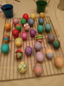 colored Easter eggs drying on a drying rack
