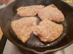 chicken frying in a skillet