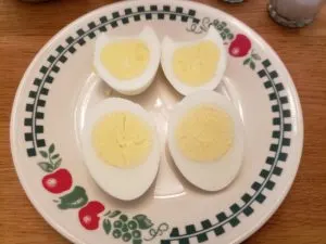 2 hard boiled eggs cut in half on plate