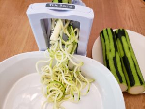 zoodles coming out of spiralizer