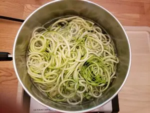 zoodles in saucepan with water