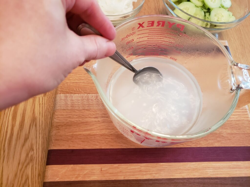 stiring sweetener into liquid in measuring cup
