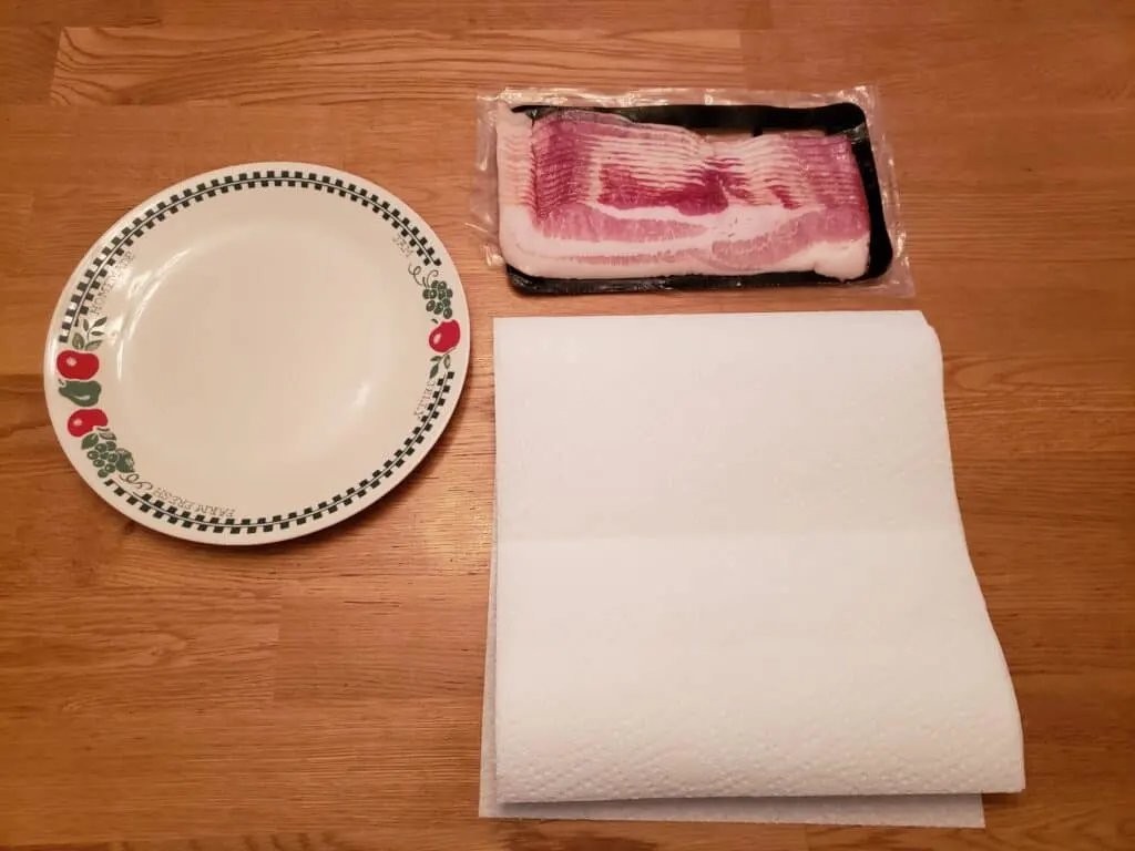package of bacon, plate, paper towels