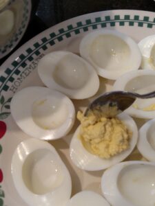 filling deviled egg halves with yolk mixture