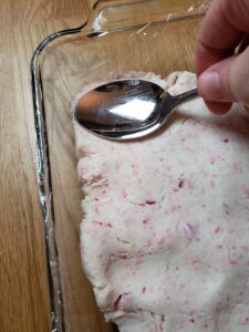 spreading Easy Keto Peppermint Fudge in pan