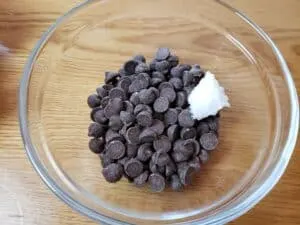 chocolate chips and coconut oil in glass bowl
