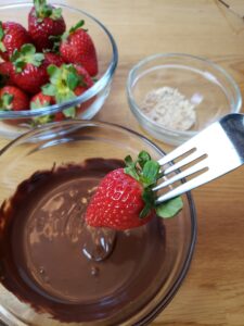 dipping strawberry into chocolate
