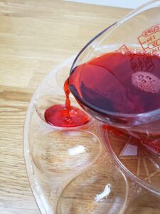 pouring red jello into mold