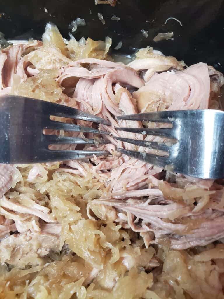 shredding Crock Pot Pork and Sauerkraut