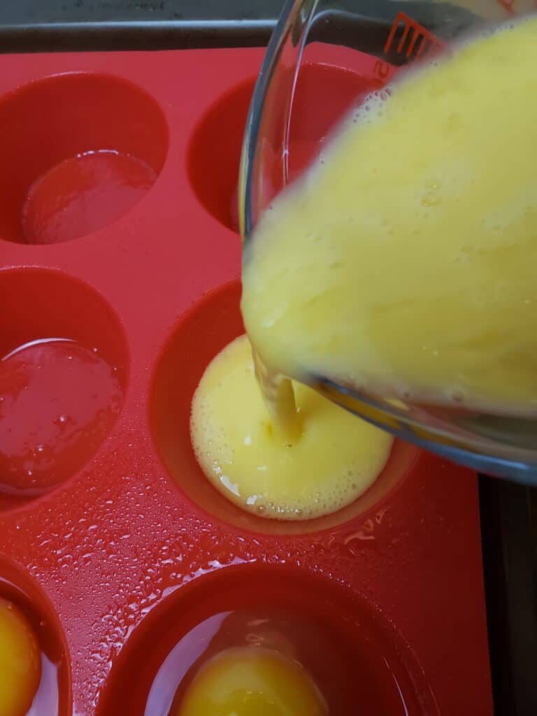 pouring scrambled eggs into muffin pan