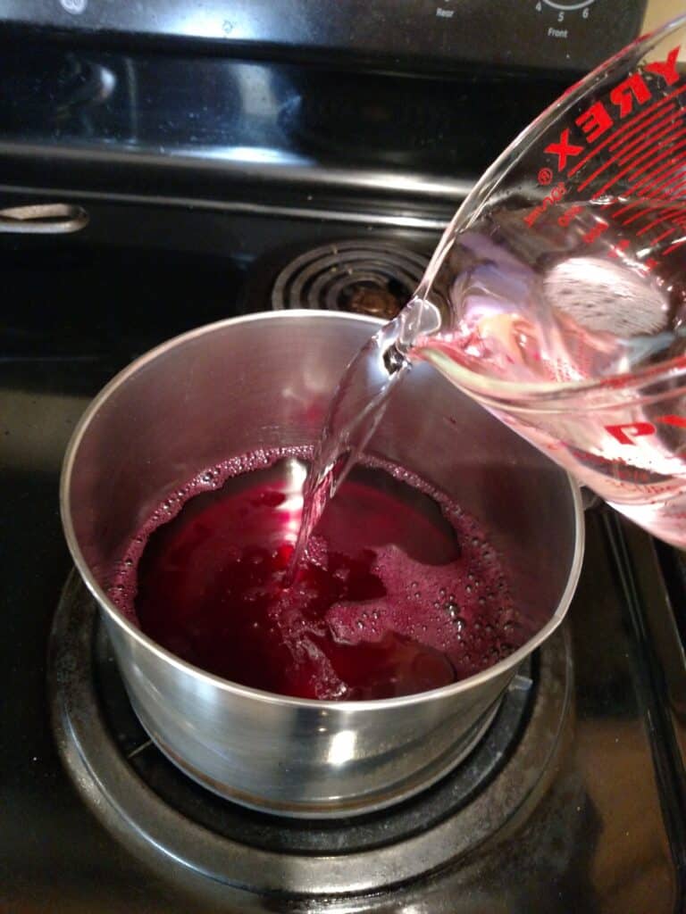 adding vinegar to pan with beet juice