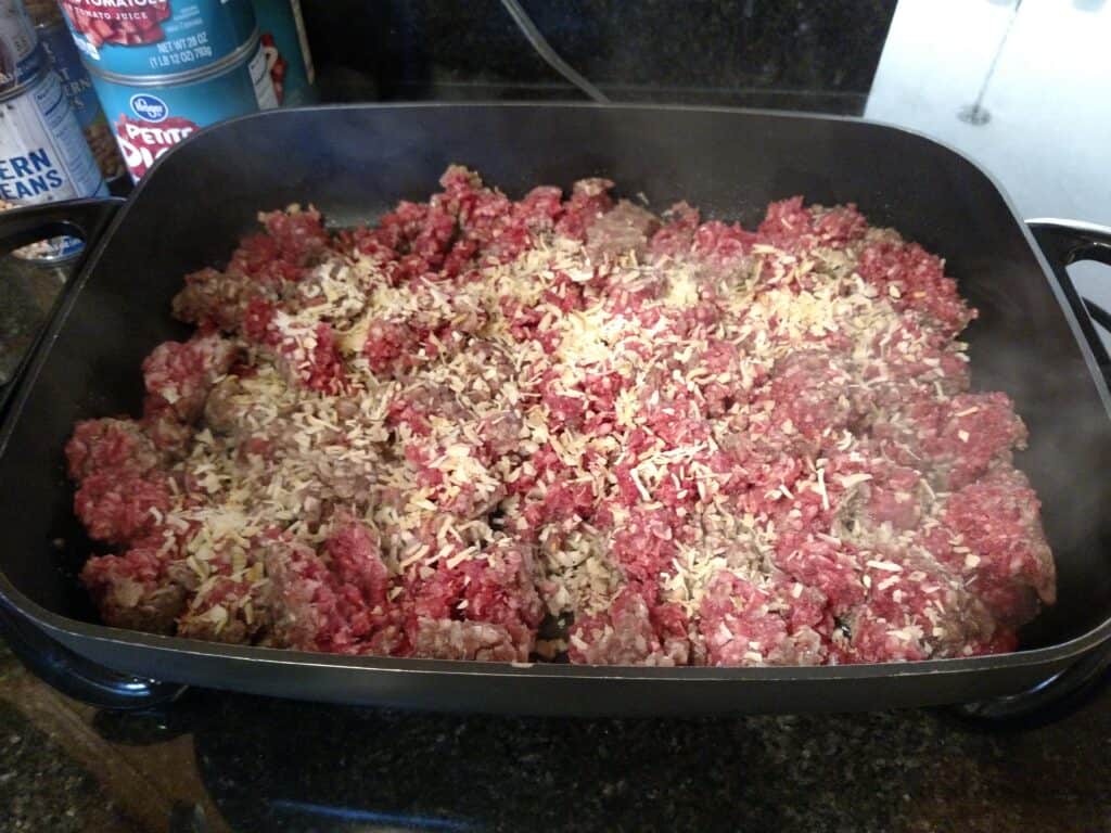 ground beef and onion cooking in skillet