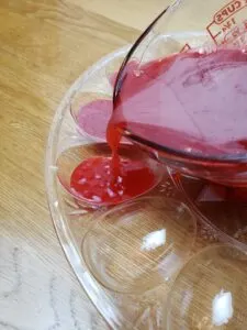 pouring red jello into deviled egg mold