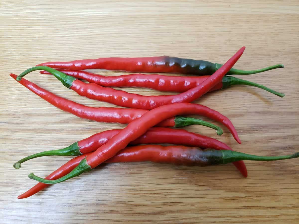 7 cayenne peppers on table