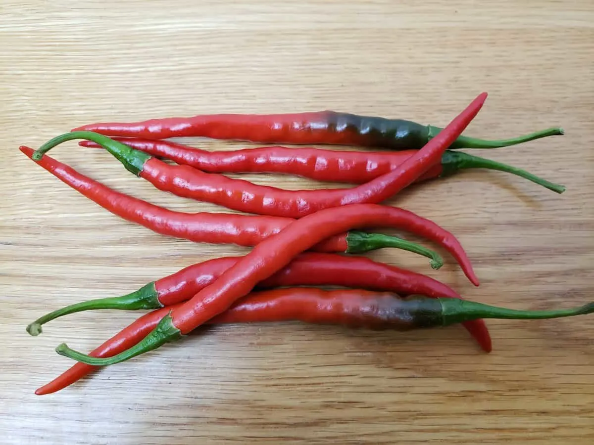 7 cayenne peppers on table