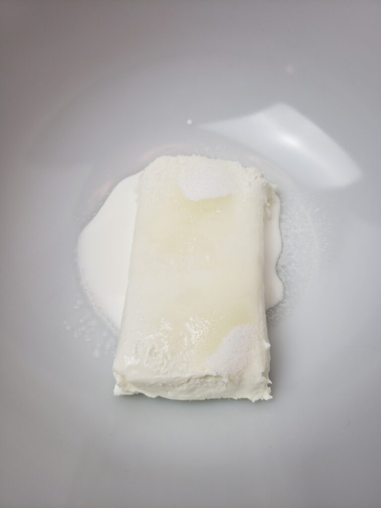 cream cheese, milk and sugar in bowl