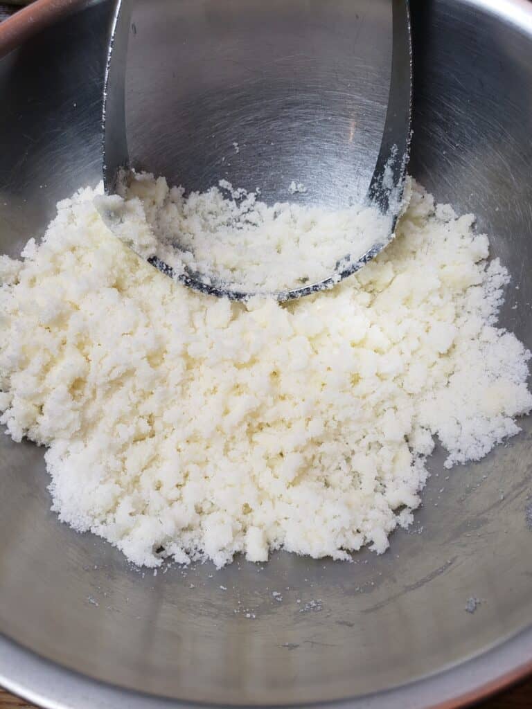 mixing butter and sugar with pastry cutter