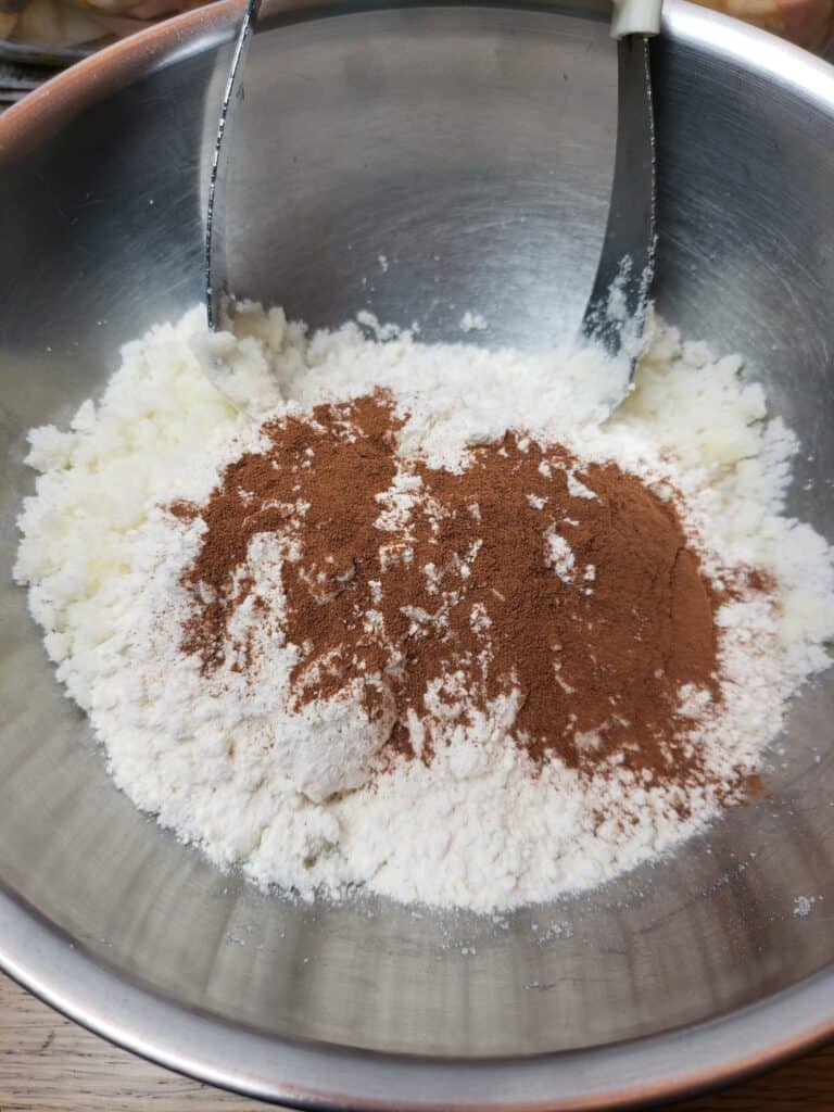 sugar, flour, cinnamon and butter in bowl