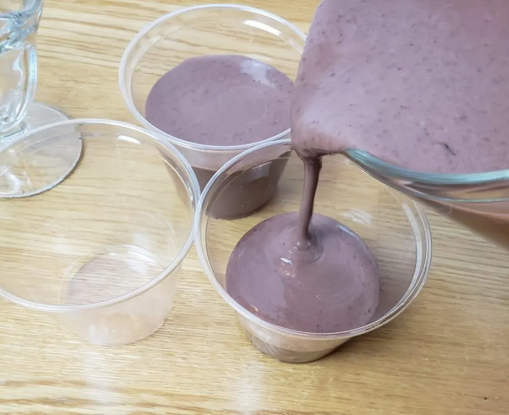pouring pudding into cups