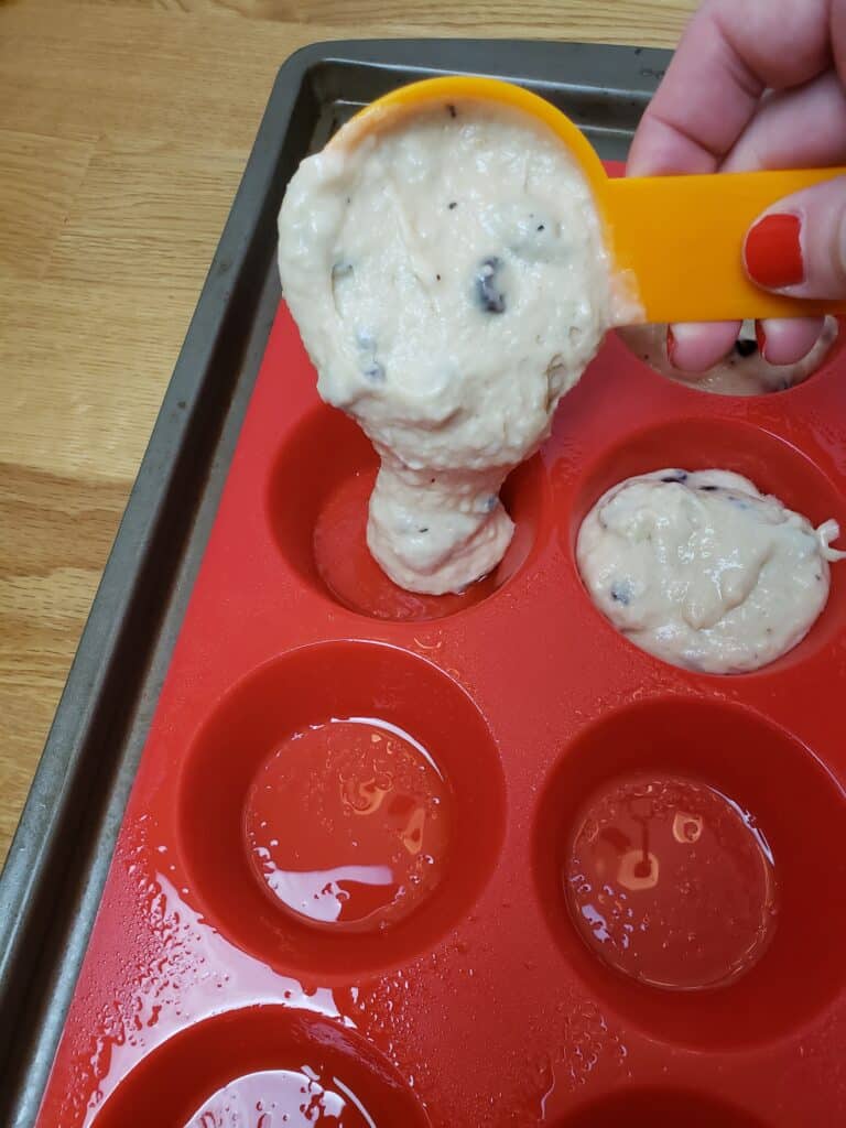 adding batter to muffin pan