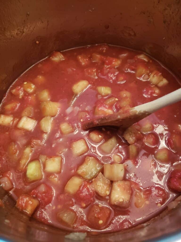stirring in tomato sauce