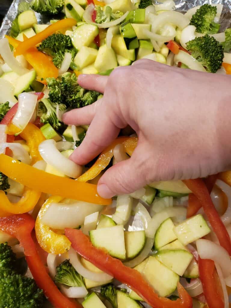 mixing vegetables with fingers