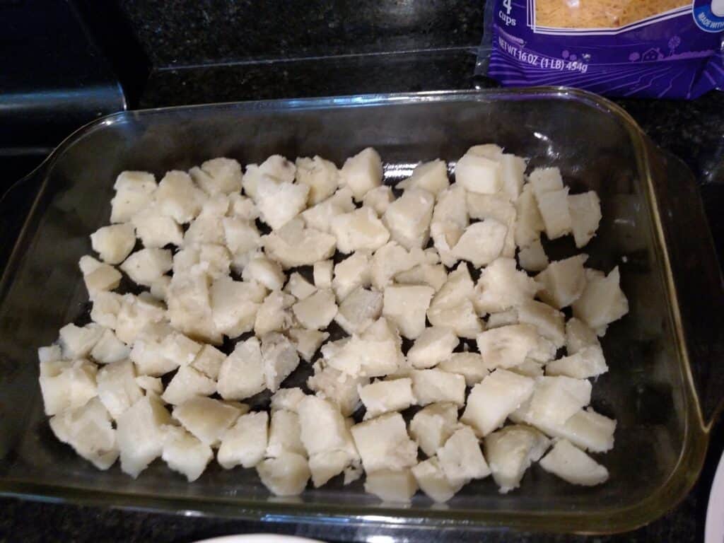 layer of cubed baked potatoes in baking dish