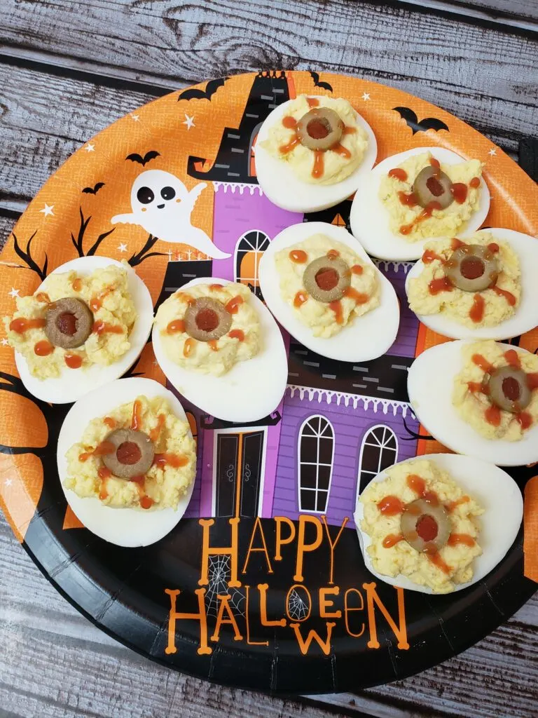 Halloween Bloodshot Eyes Deviled Eggs on festive Halloween plate.