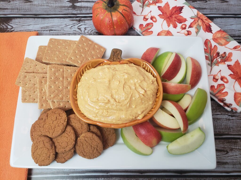 Pumpkin Dip on serving platter with graham crackers, ginger snaps and apple slices.