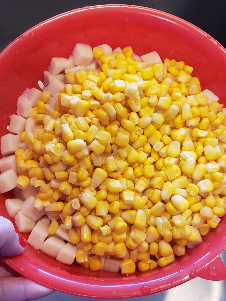 canned potatoes and corn in strainer
