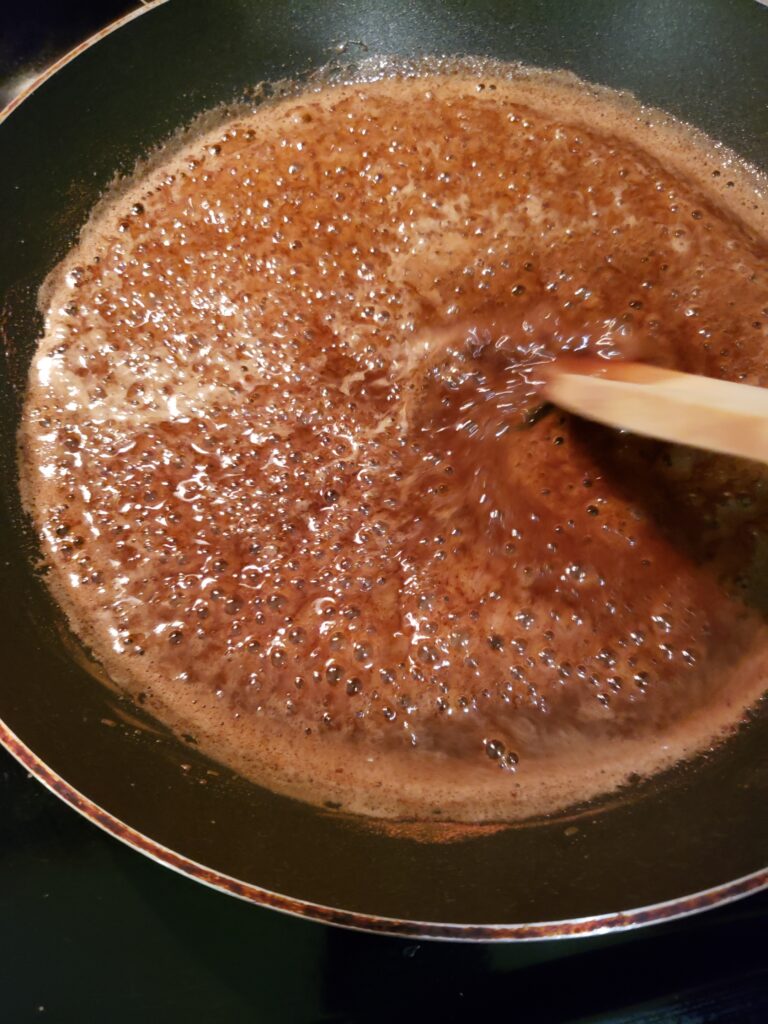 stirring sugar, cinnamon, salt, vanilla and water in skillet