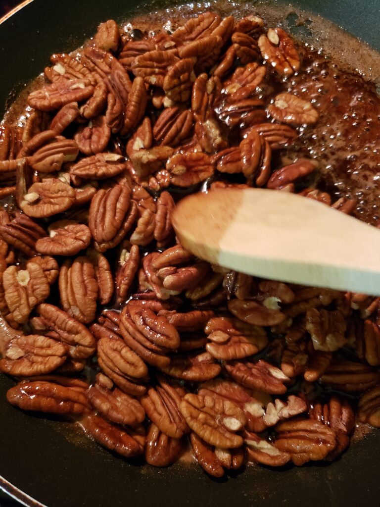 stirring pecans into candy mixture