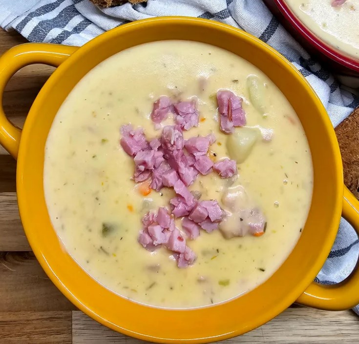 creamy garlic potato soup in yellow bowl