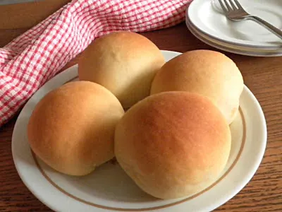 4 soft butter rolls on a plate
