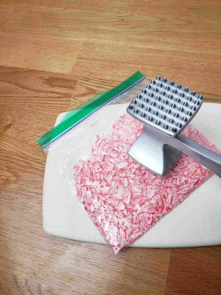 crushing candy canes with a meat tenderizer