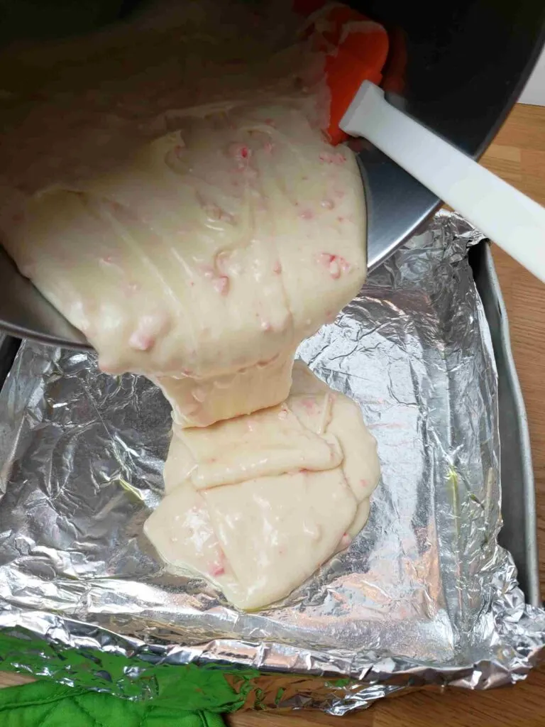 pouring fudge into pan
