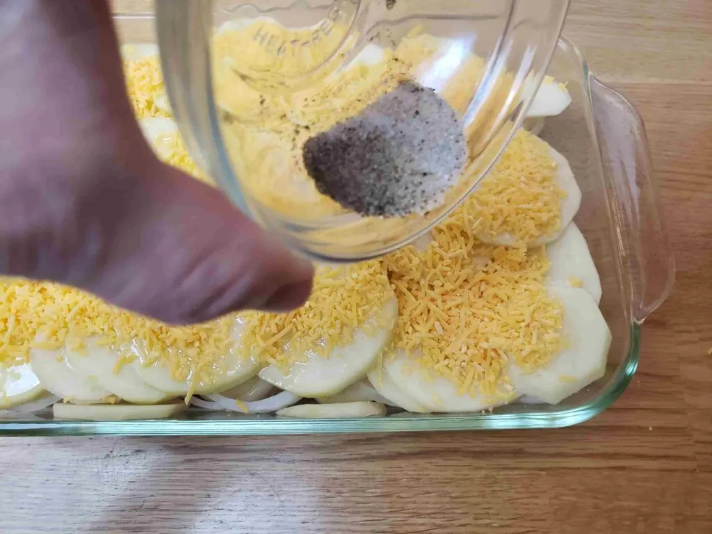 sprinkling spices over cheese