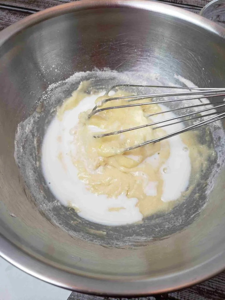 adding part of egg and sugar mixture