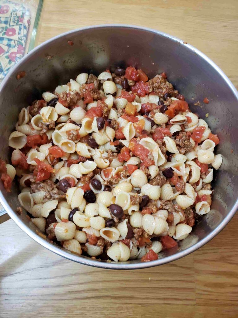 pasta, tomatoes, beans and meat combined in pot