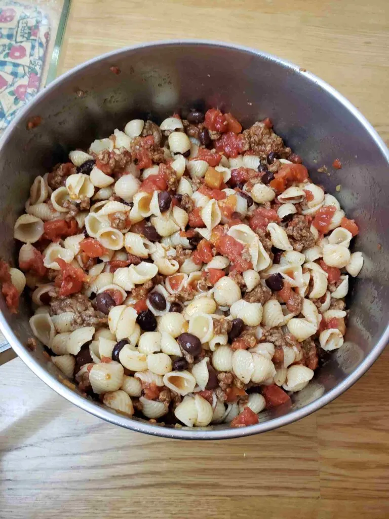 pasta, tomatoes, beans and meat combined in pot