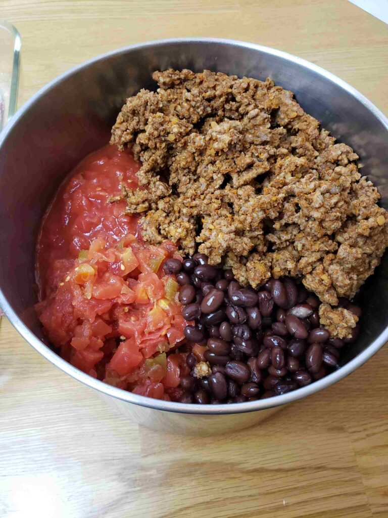 taco meat, tomatoes and black beans in pot