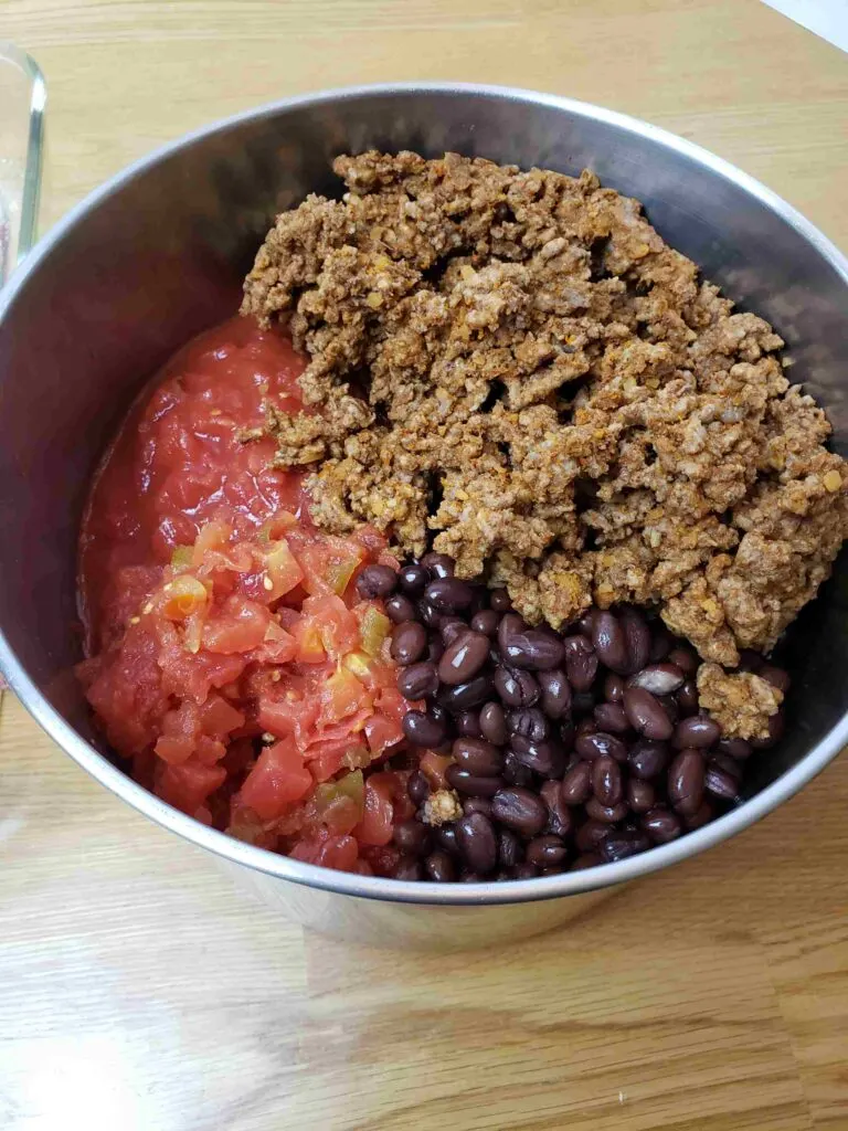 taco meat, tomatoes and black beans in pot