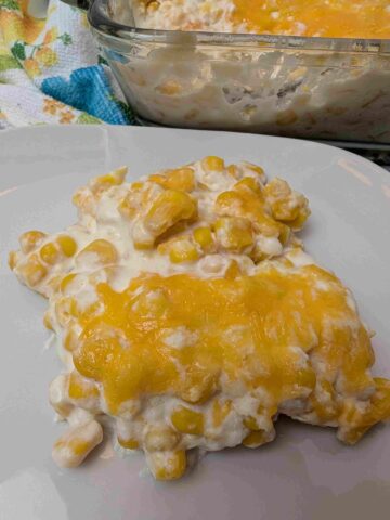 a serving of cheese corn casserole on a white plate