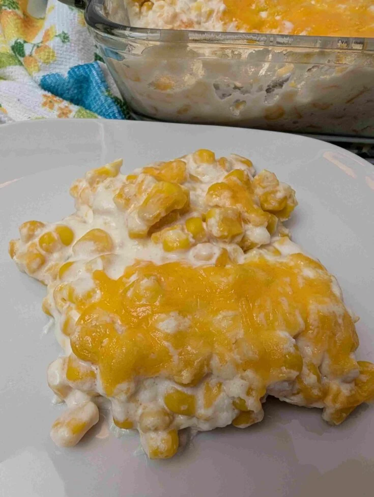 a serving of cheese corn casserole on a white plate