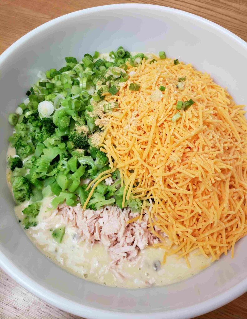 cheese, chicken, broccoli, onion and garlic powder added to bowl