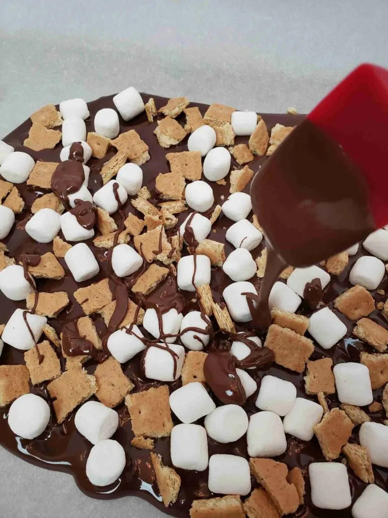 drizzling chocolate over s'mores bark