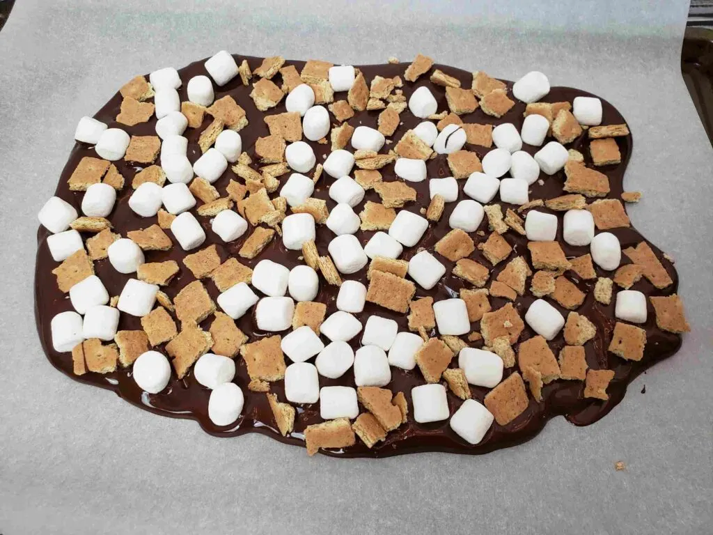 mini marshmallows and broken graham crackers on melted chocolate