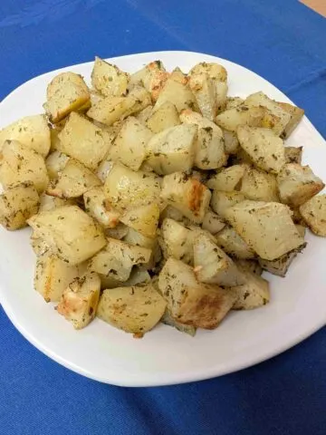 oven roasted ranch potato bites on white plate on blue napkin